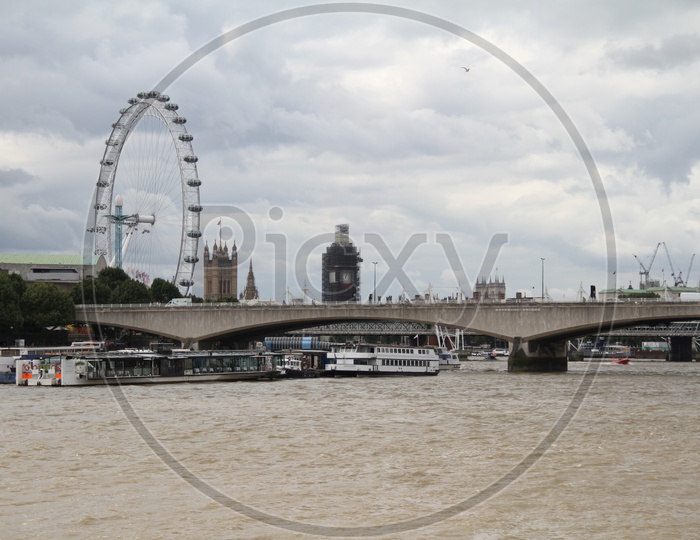 Tourist Boats on Thames River with London Eye in Background