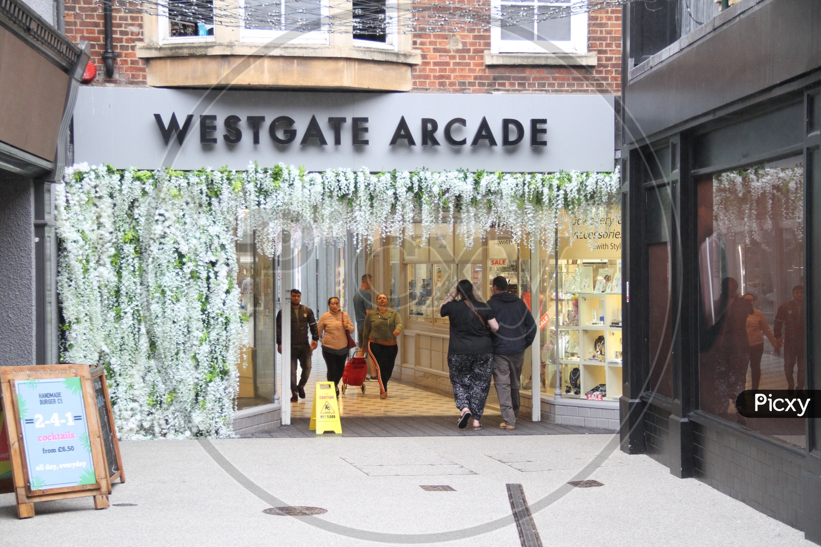People going into Westgate Arcade