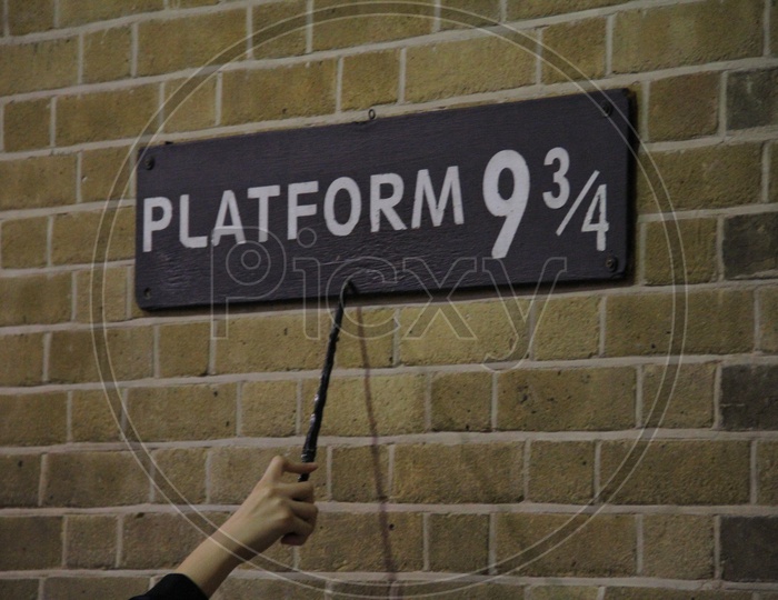 Magic Wand Pointing at Platform 9 3/4 Sign from Harry Potter movie in King's Cross Station