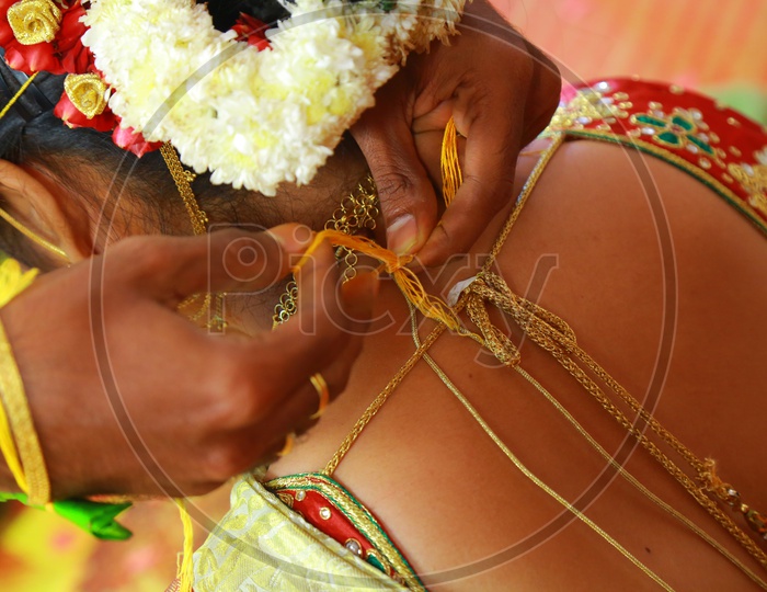 Indian Bride Groom tying Mangalsutra