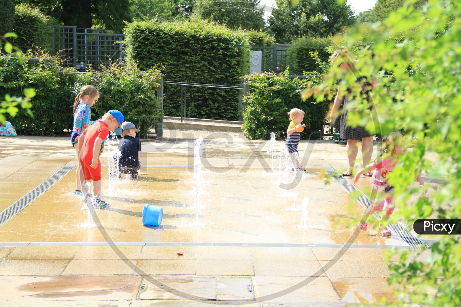 Children having fun with Water Fountain, Kids Playing