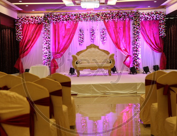 A decorated stage with maharaja chair with lighting