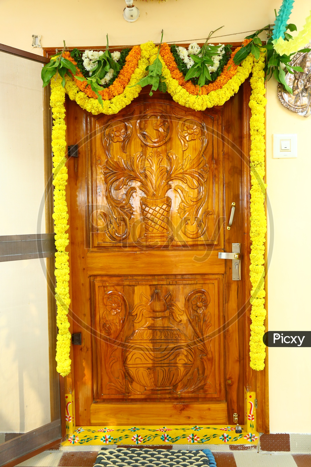 A wooden door decorated with garlands