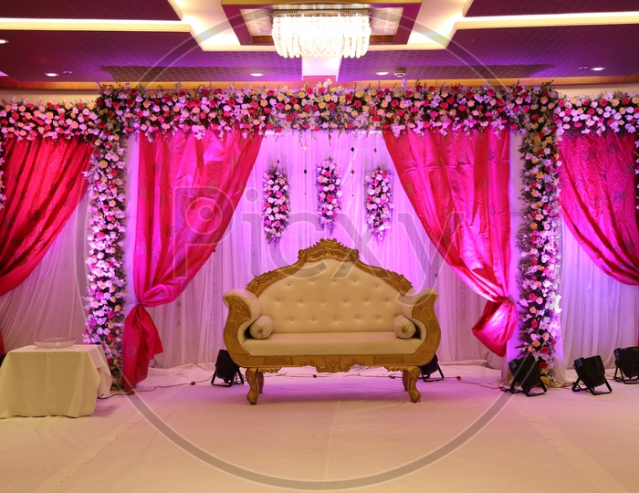 A Stage decorated with flowers and focus lights