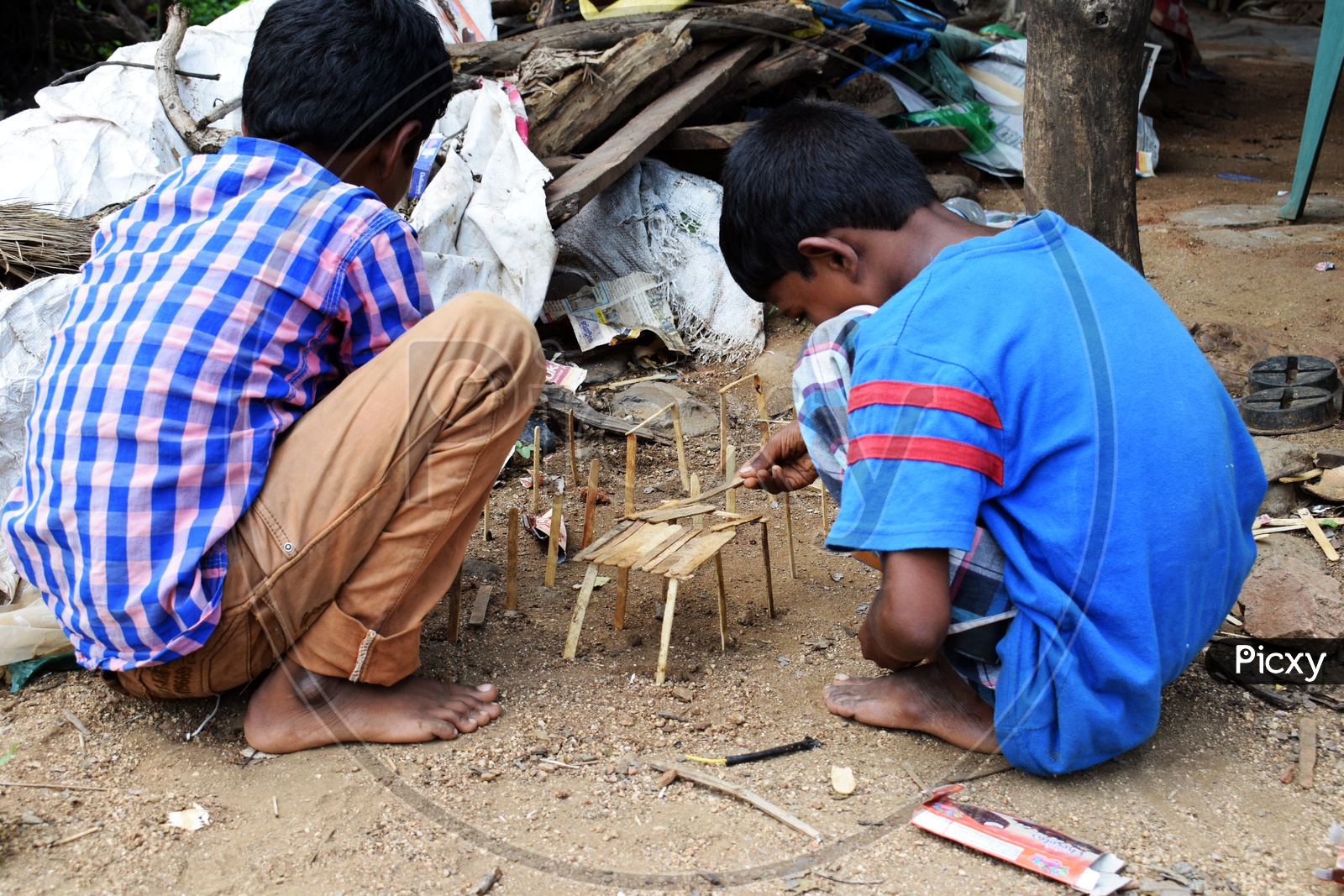Children observe a lot, Encourage Children's Creative play. Children making toy house with sticks. 