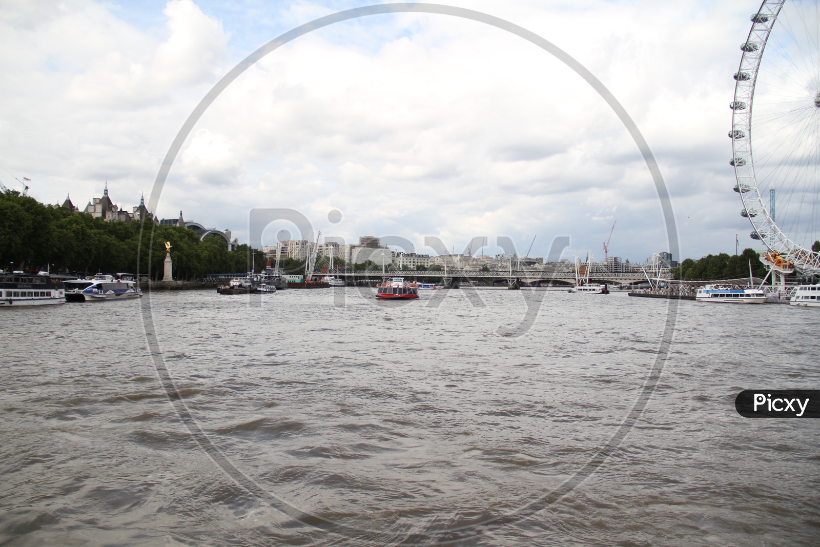 Tourist Boats on Thames River with Clouds in Background