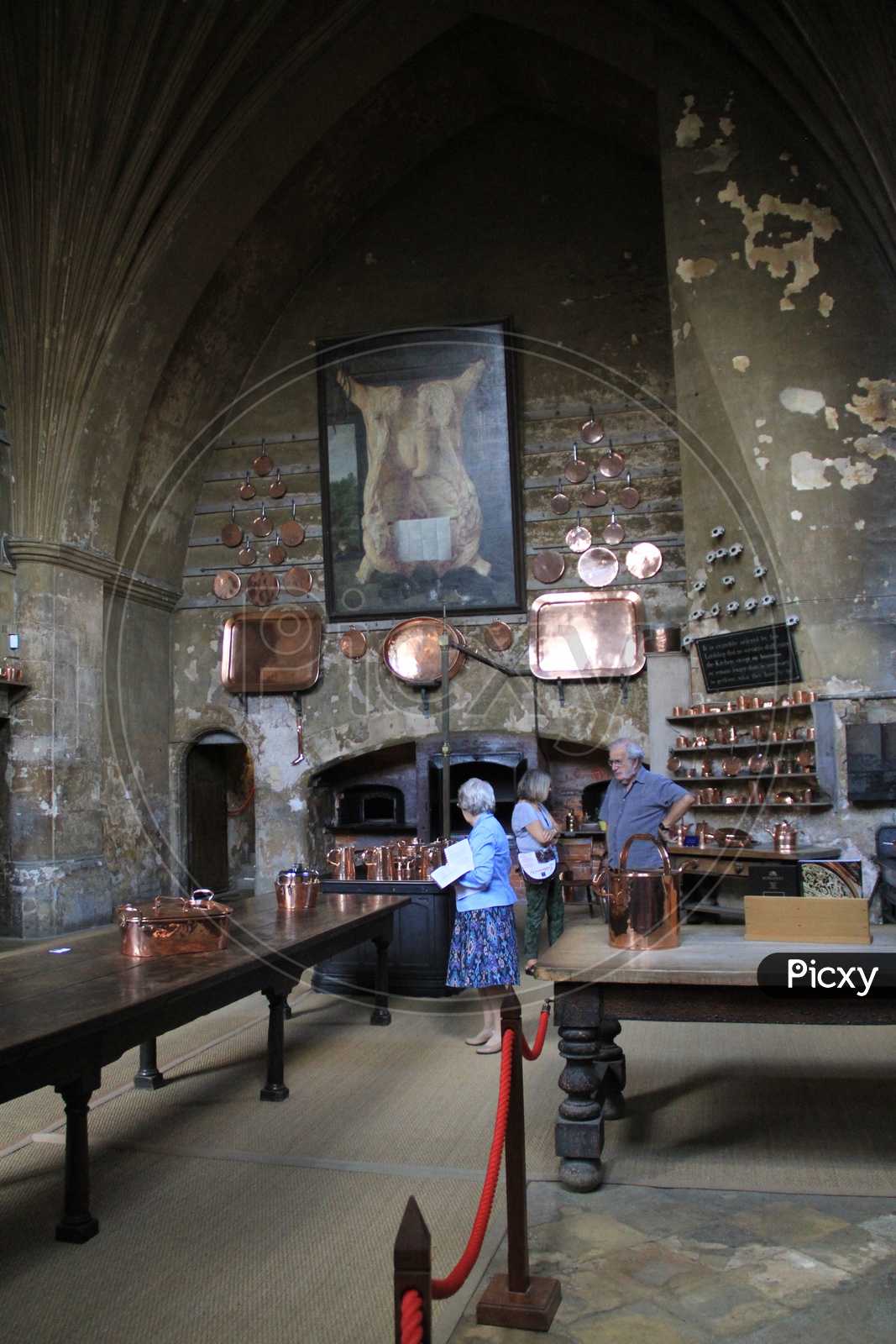 Tourists at Burghley House checking Copper Utensils in Kitchen