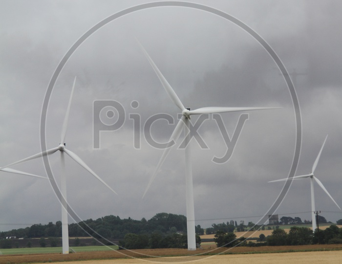 Wind Turbines with Clouds in Sky Background