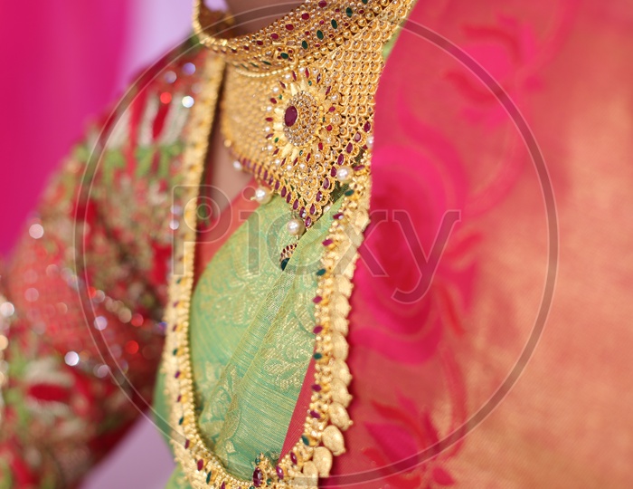 Indian Woman wearing Gold Haaram