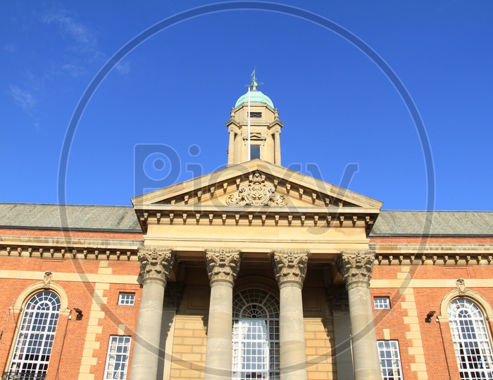 Facade Of a  Palace With Pillars And Blue Sky As Background
