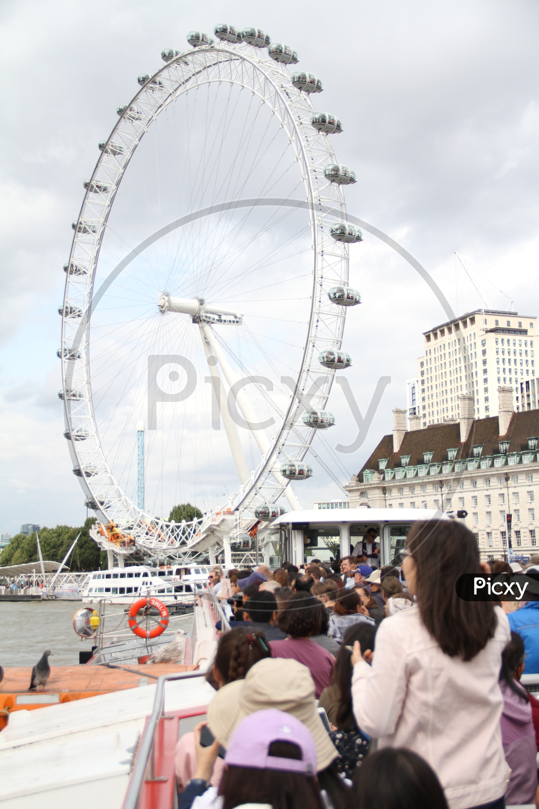 Tourists at London Eye or Large Ferris Wheel