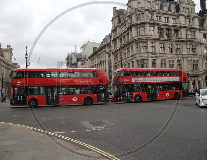Red Double Decker Buses with People at Parliament Square London