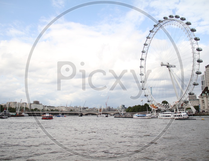 London Eye and Tourist Boats on River