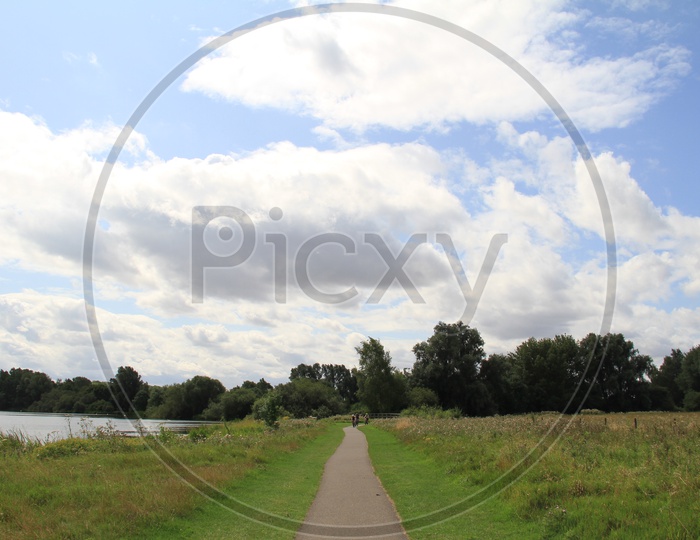 Pathway in Ferry Meadows Caravan and Motorhome Club Site with Clouds in Sky Background