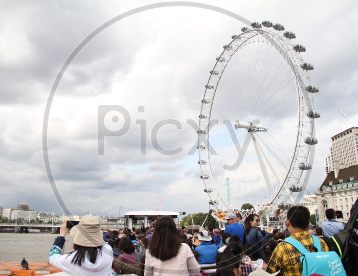 Tourist Boat on Thames River and London Eye