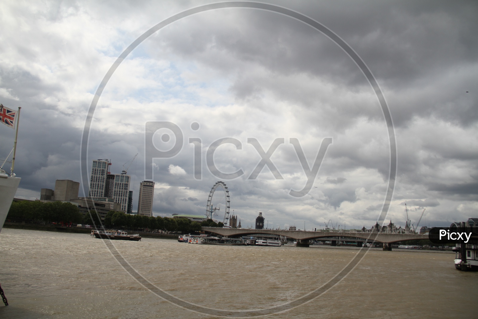 Thames River with London Eye Ferris Wheel and Clouds in Background