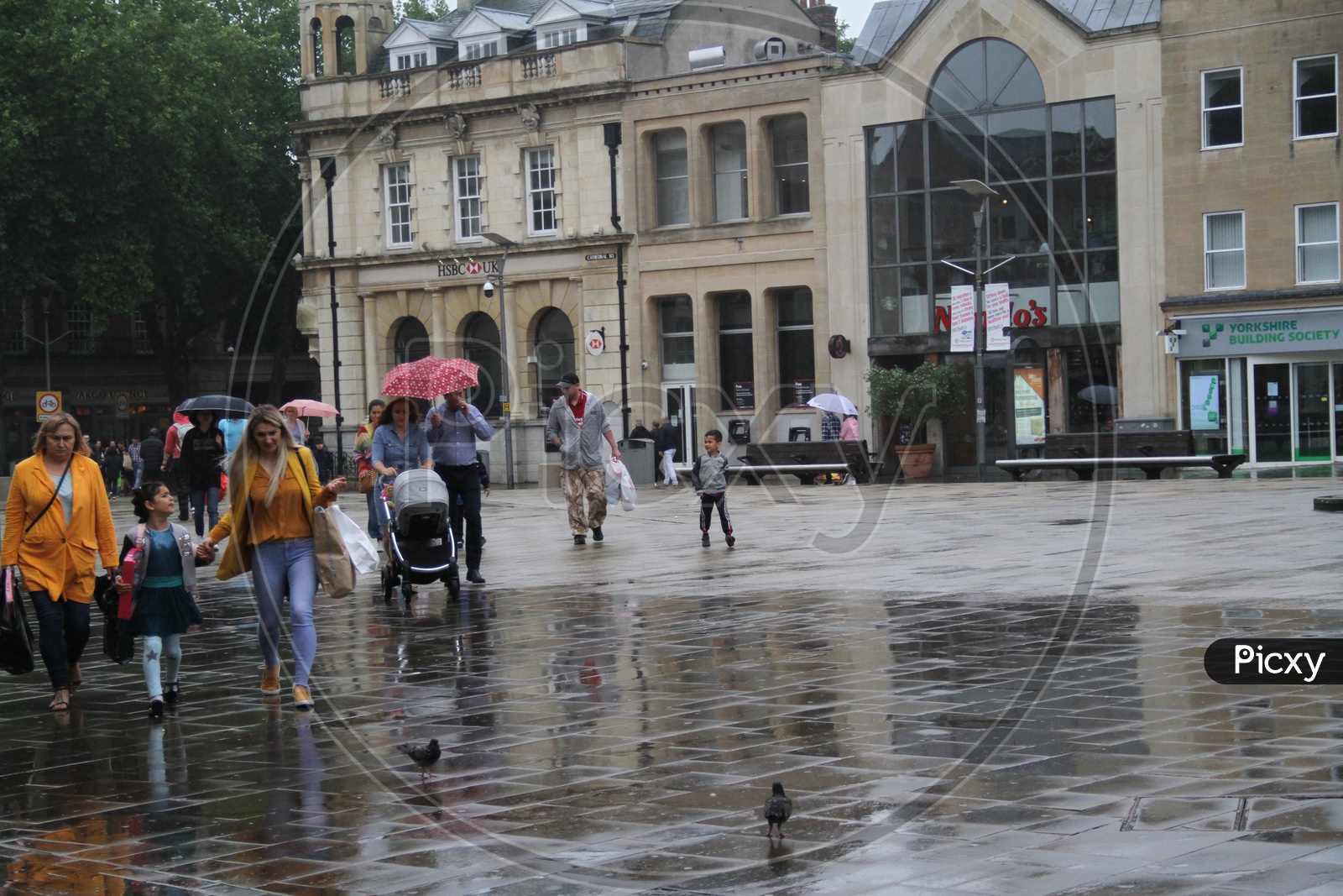 People walking in London Streets while raining