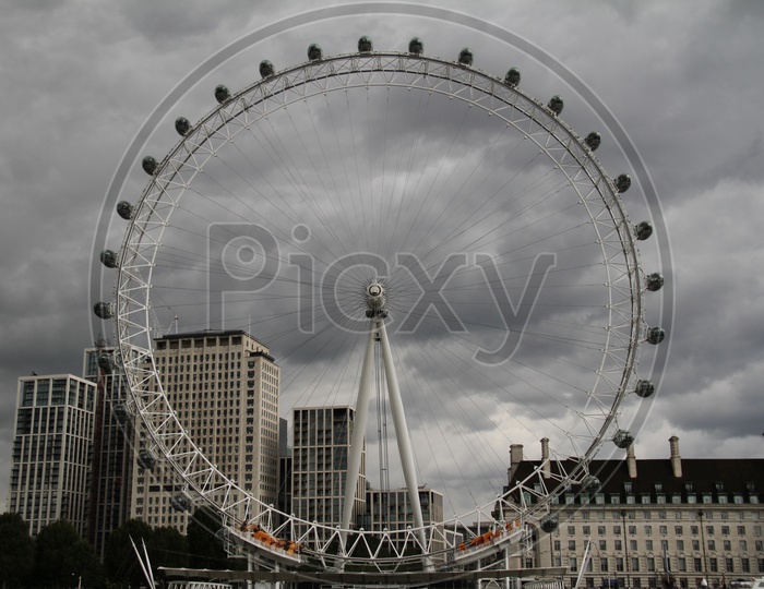 Closeup Shot of London Eye or Ferris Wheel with Dark Clouds in Background