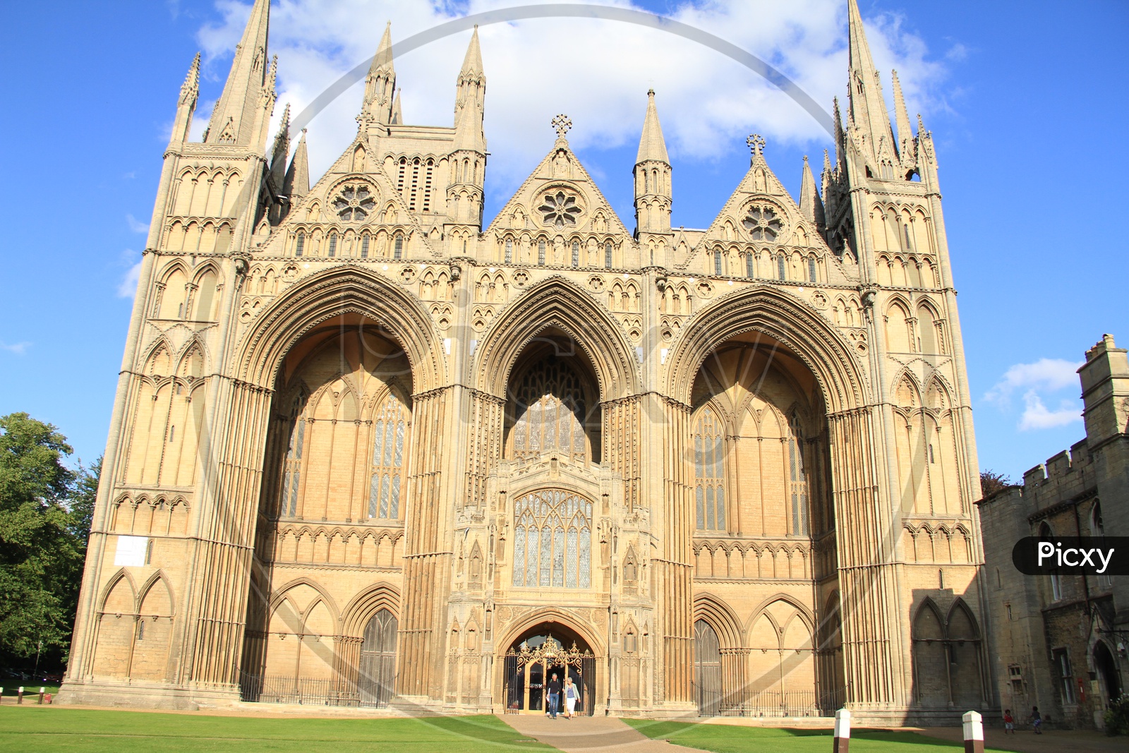 Tourists at Peterborough Cathedral with Clouds in Sky