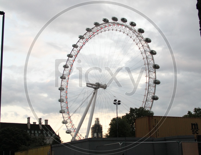 London Eye Ferris Wheel with Dark Clouds in Background