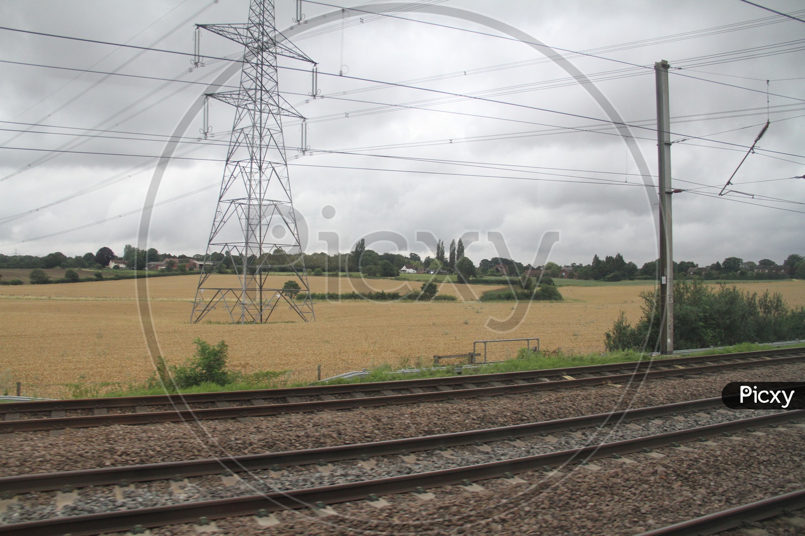 Power Transmission Lines in Agriculture Fields near Railway Tracks