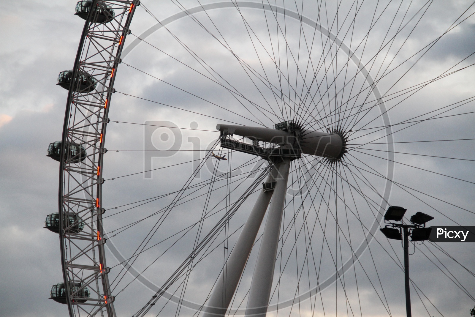 Closeup Shot of London Eye with Flight in Background