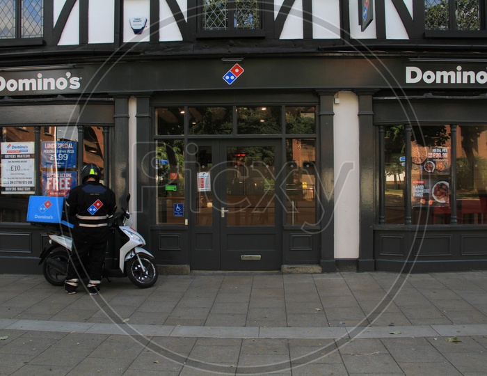 Domino's Delivery Boy with Bike outside a Outlet in London