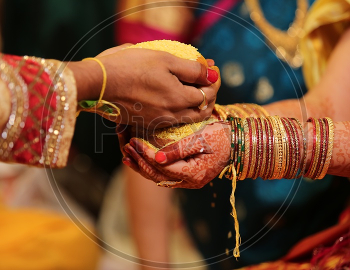 Talambralu in the hands of Bride and Groom