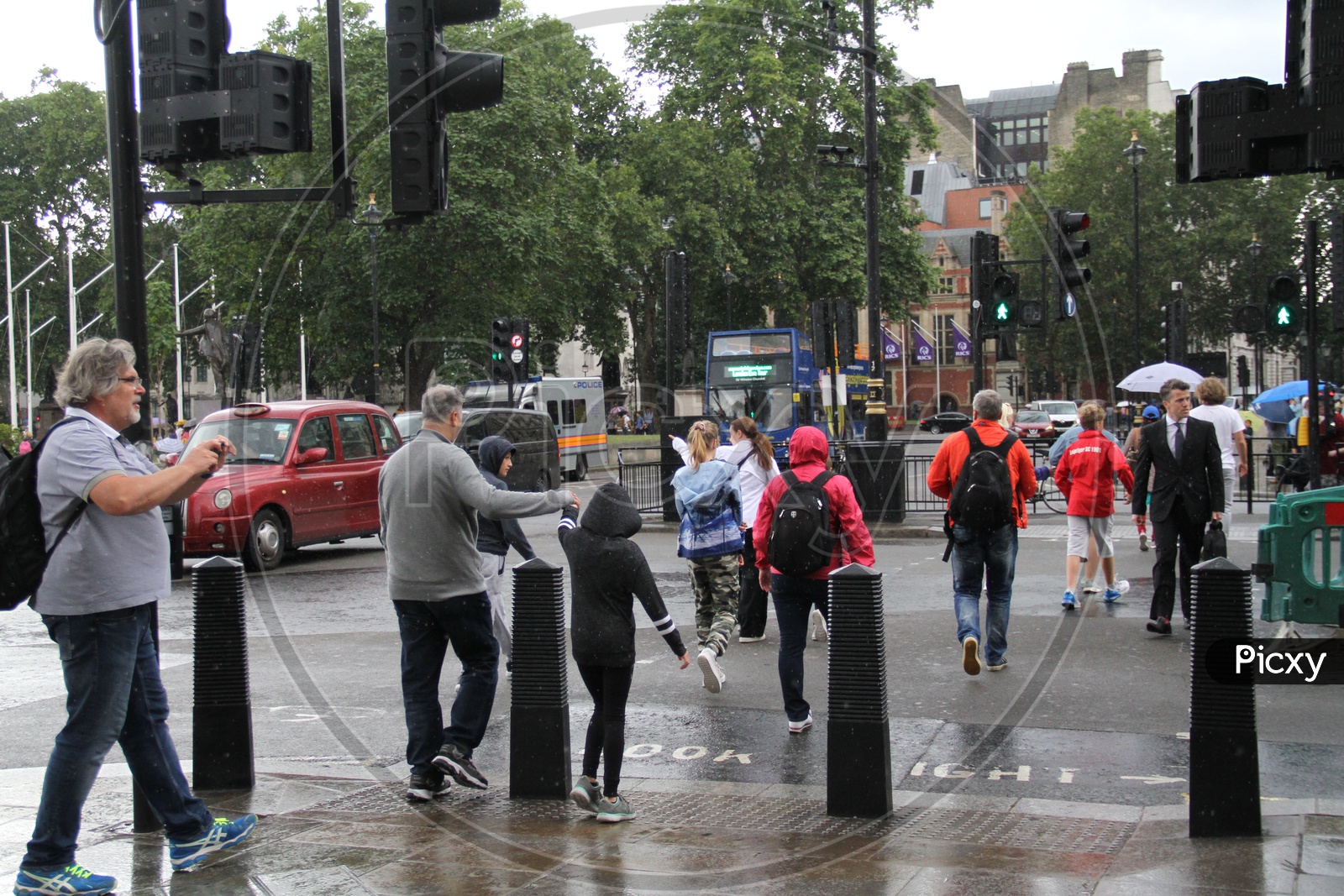 Pedestrians crossing the road on green light