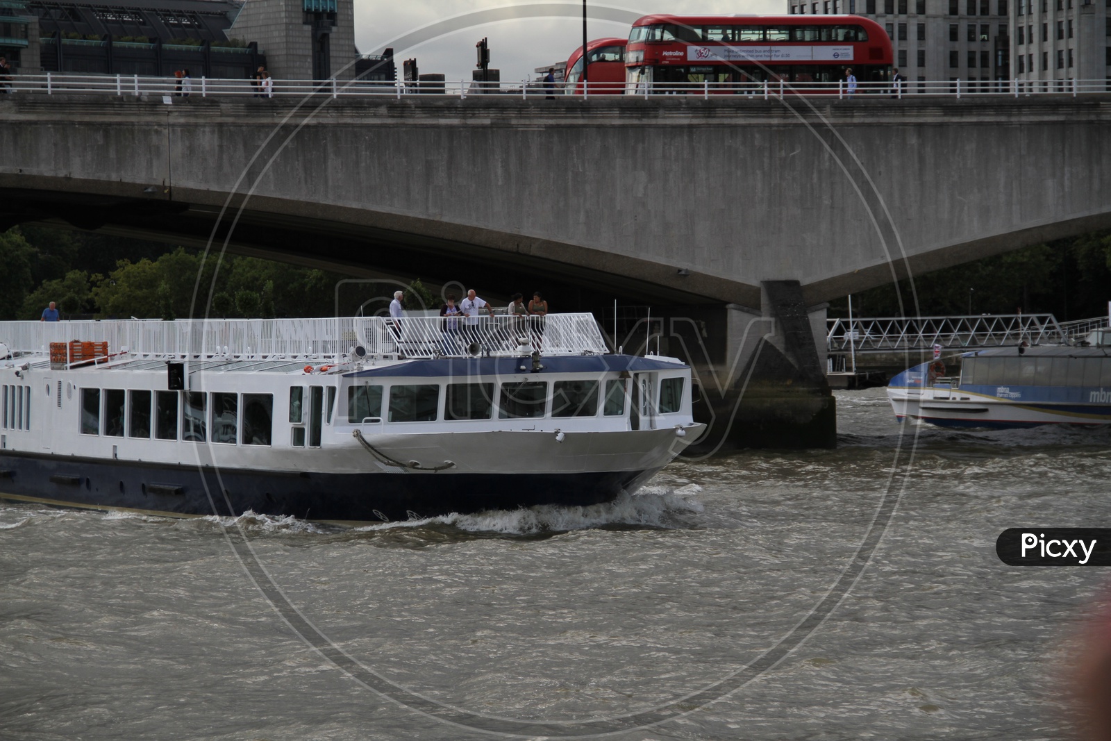 Tourist Boat crossing a Bridge