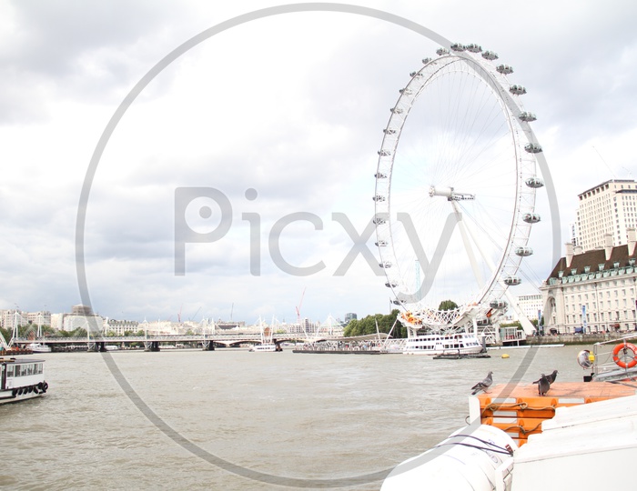 London Eye and Tourist Boats on Thames River