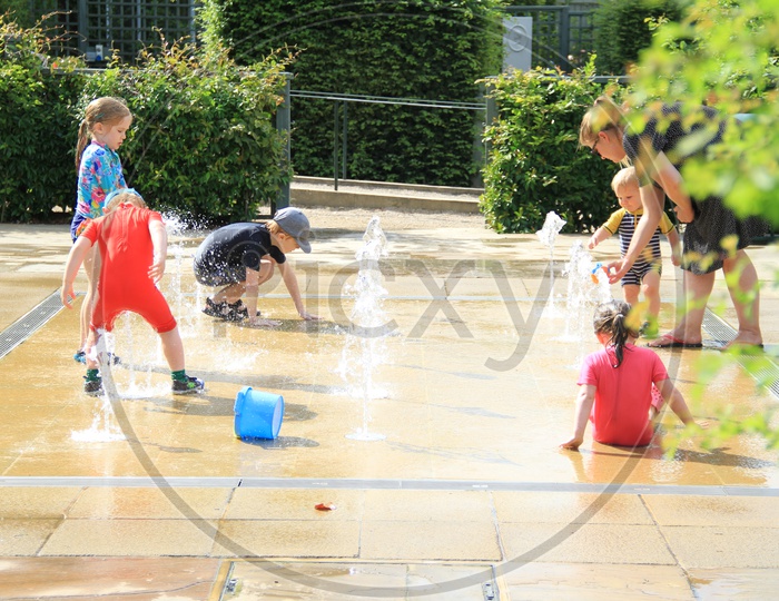 Children Playing with Water Fountain