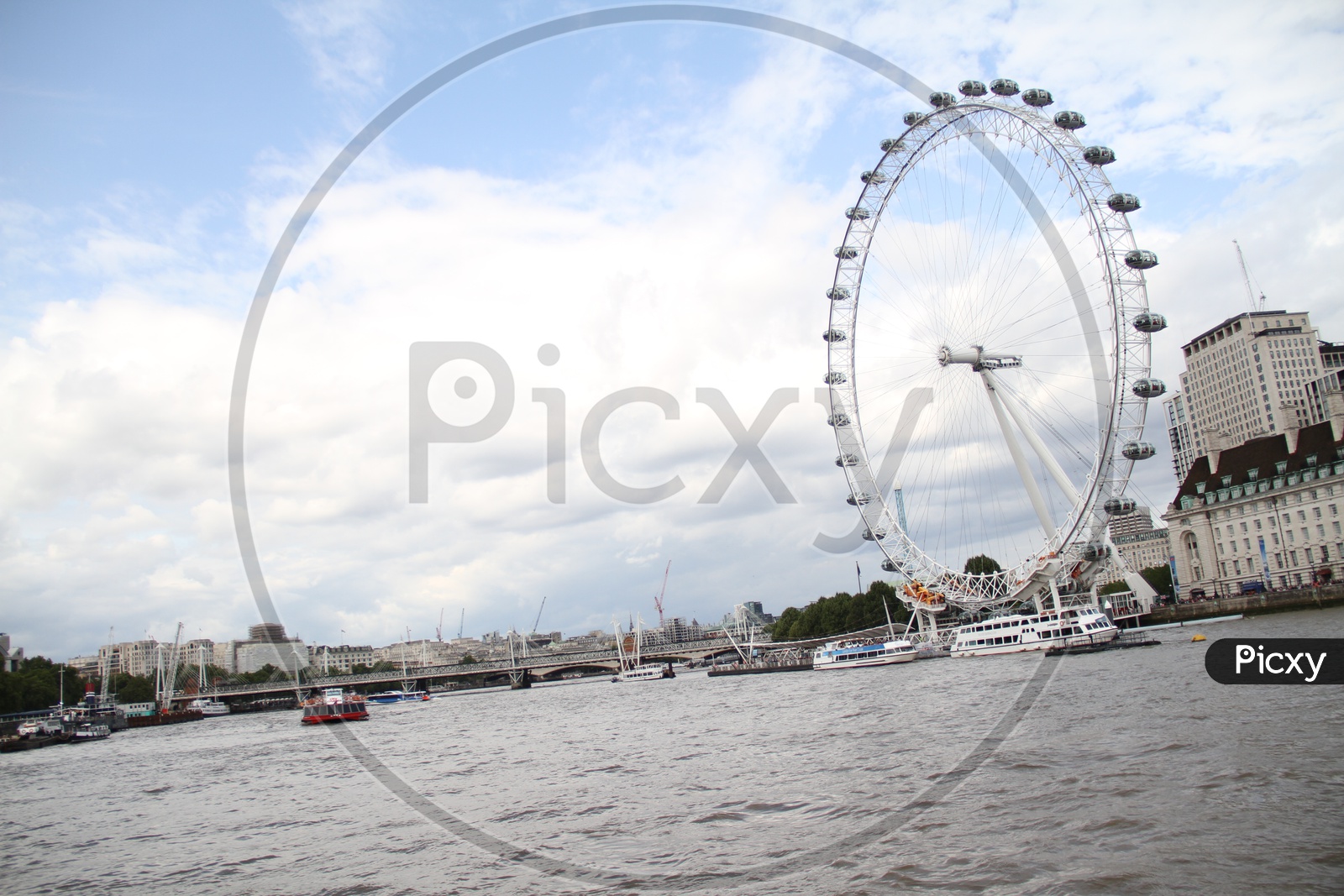Tourist Boats and London Eye with Clouds in Sky
