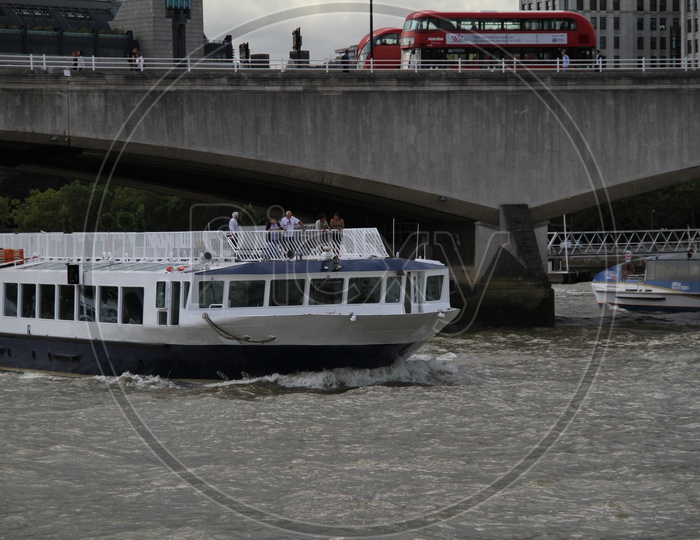 Tourist Boat crossing a Bridge