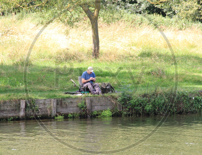 Old Man fishing near Lake