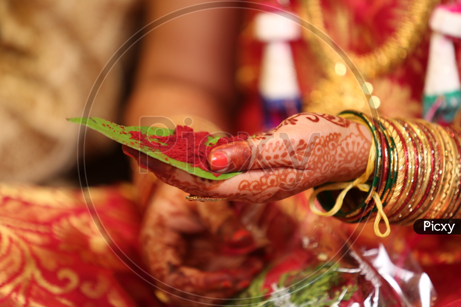 Indian bride holding Sindhura in betel leaf