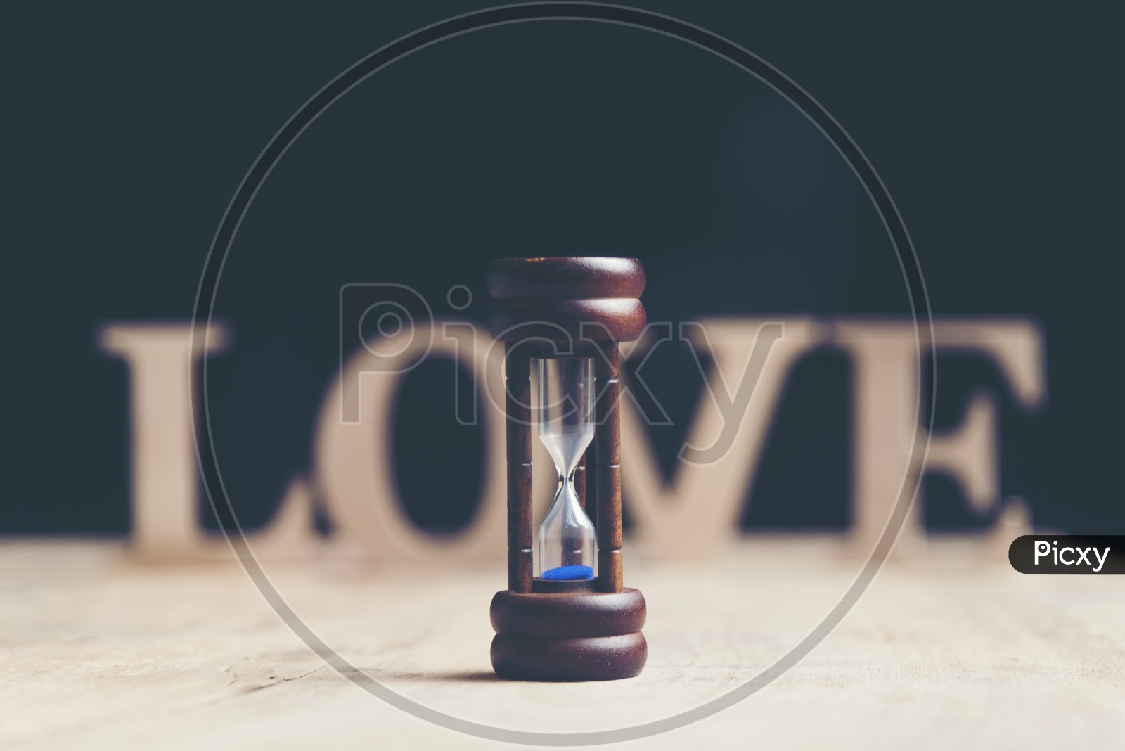 Sand Timer With LOVE Word Bokeh In Background Forming a  Template For Valentines Day