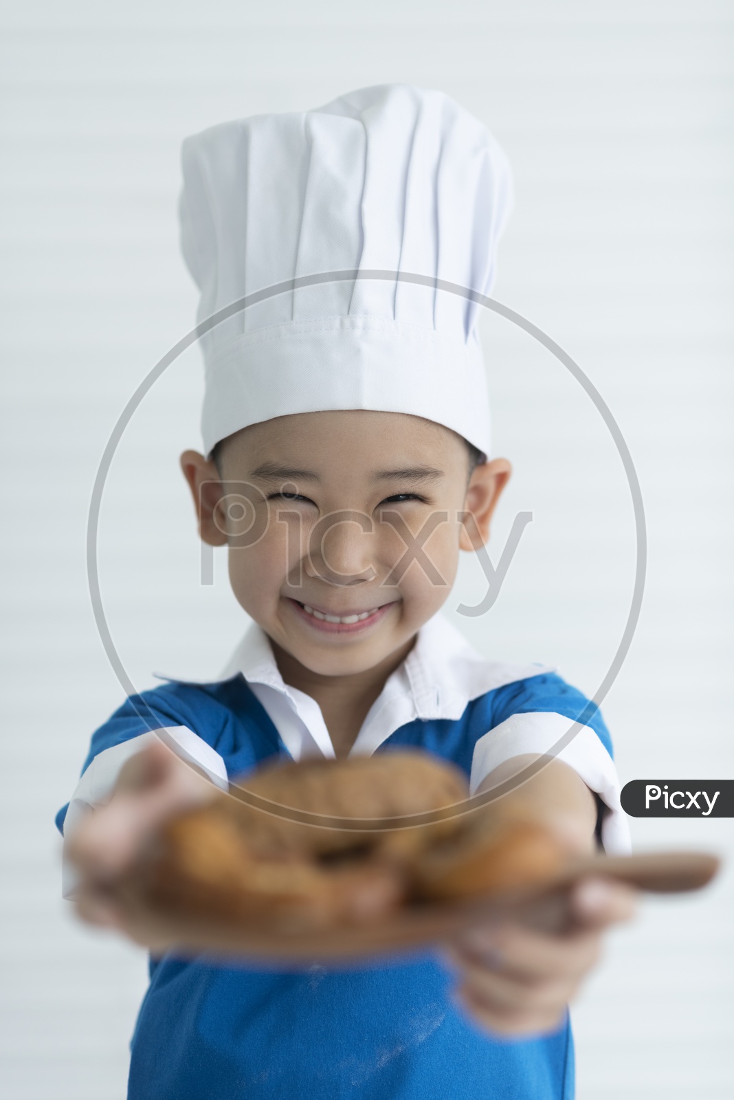 A boy as chef enjoying cooking