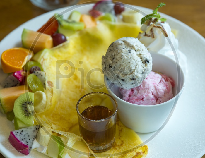 Ice Cream Served  with Fresh Fruit Salad  and Sugar Syrup