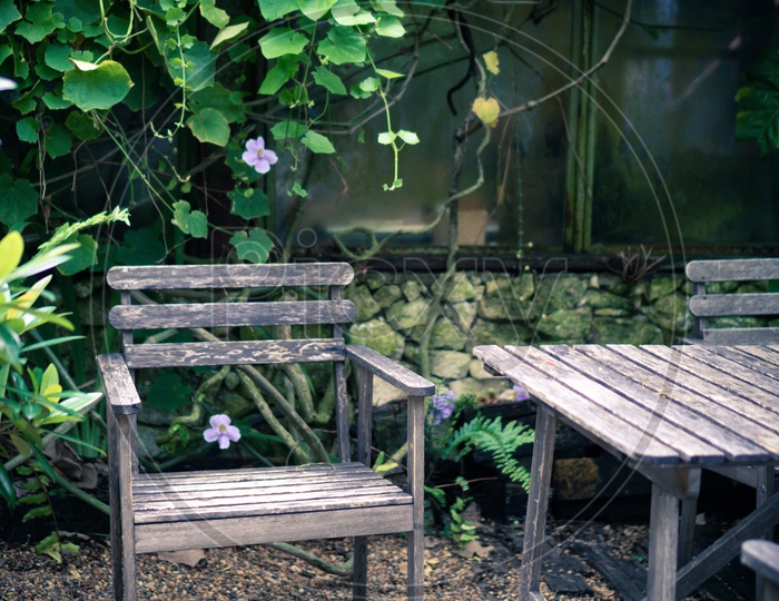 Old wooden set for outdoor furniture in tropical garden, cafe table