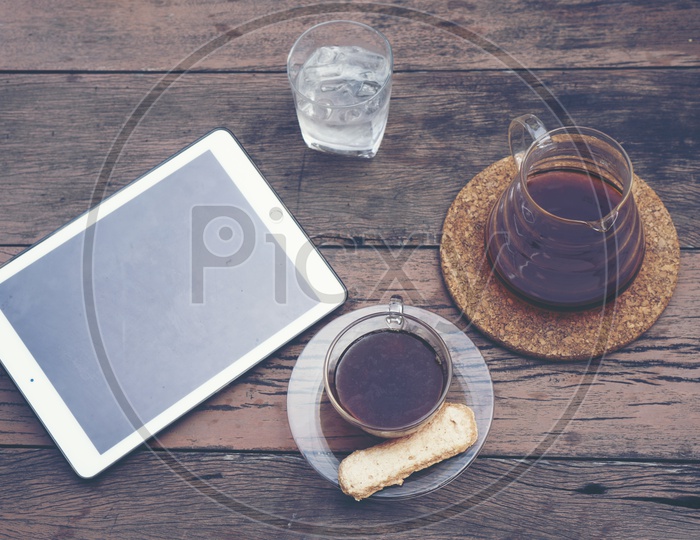 Top view of morning coffee drip with tablet for business work