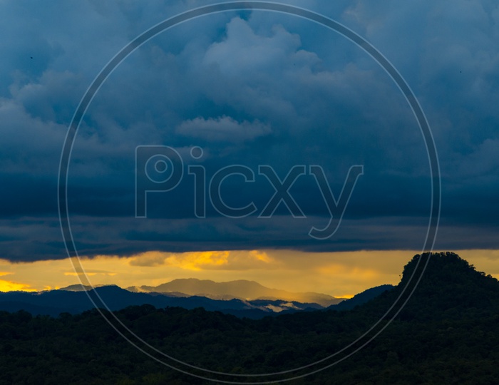 Landscape of  Tropical Forest With Trees Seamless Patterns and Mountains  Over a Sunset Sky