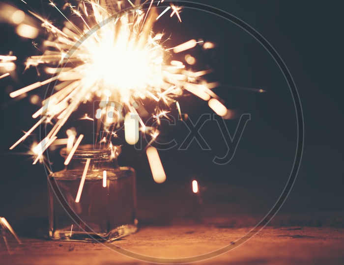 Festive Sparklers Over Black Background With Space
