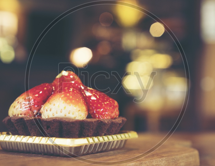 Close up a strawberry cheese cake on the wooden table