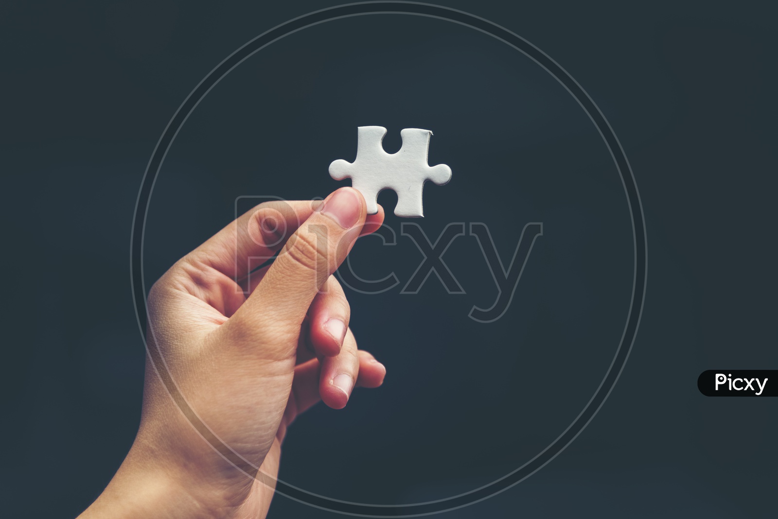 Startup Company Entrepreneur or Businessman hand connecting jigsaw puzzle.