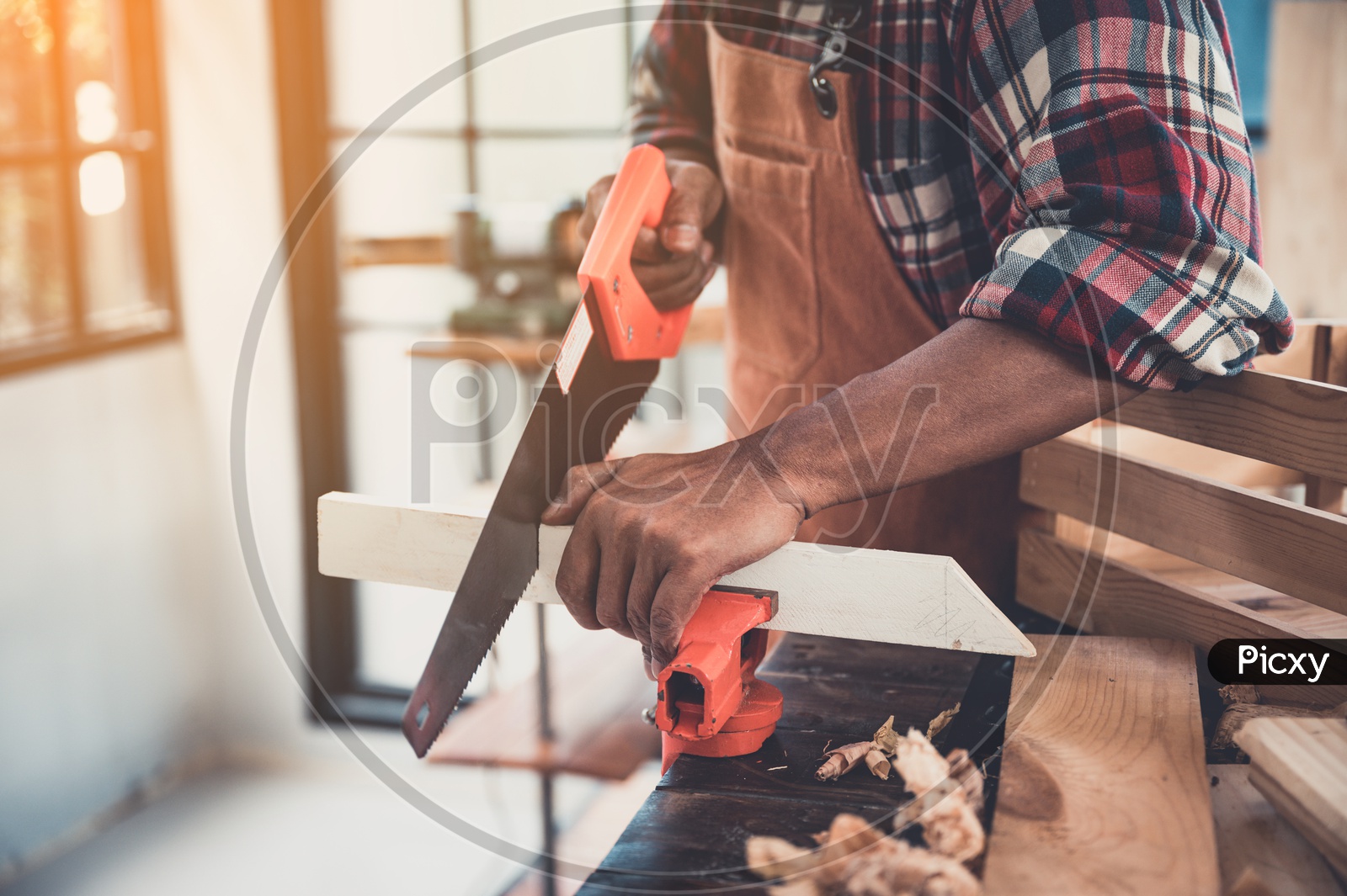 Carpenter hands working on woodworking machines in carpentry shop