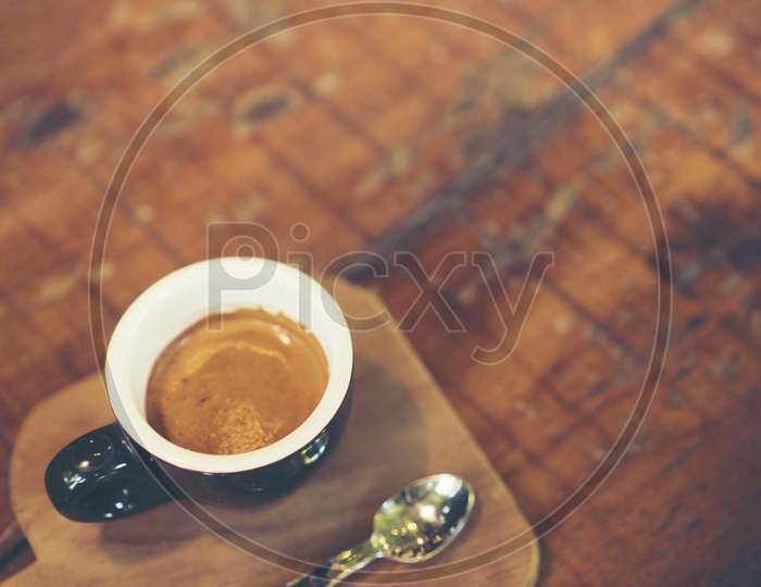 Top view of Espresso shot coffee in a black cup on a wooden tray