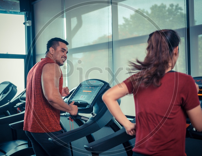 Couple exercising in the gym on treadmill