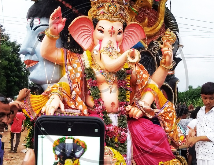 Man taking photo of Ganesha while vichcharjan.