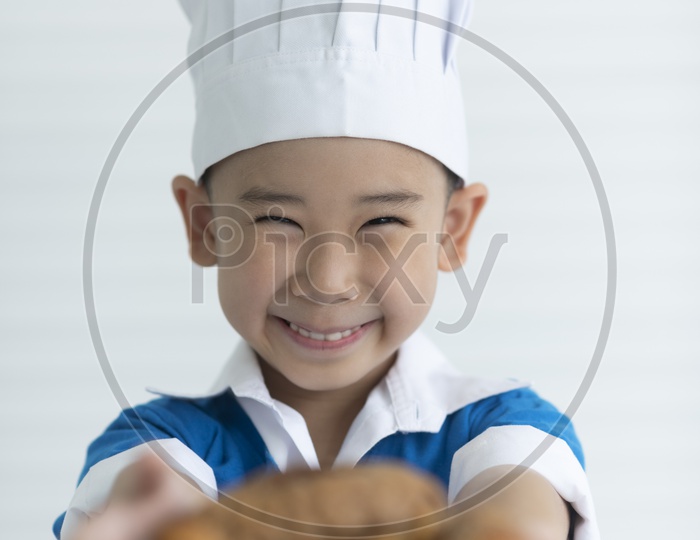 A boy as chef enjoying cooking